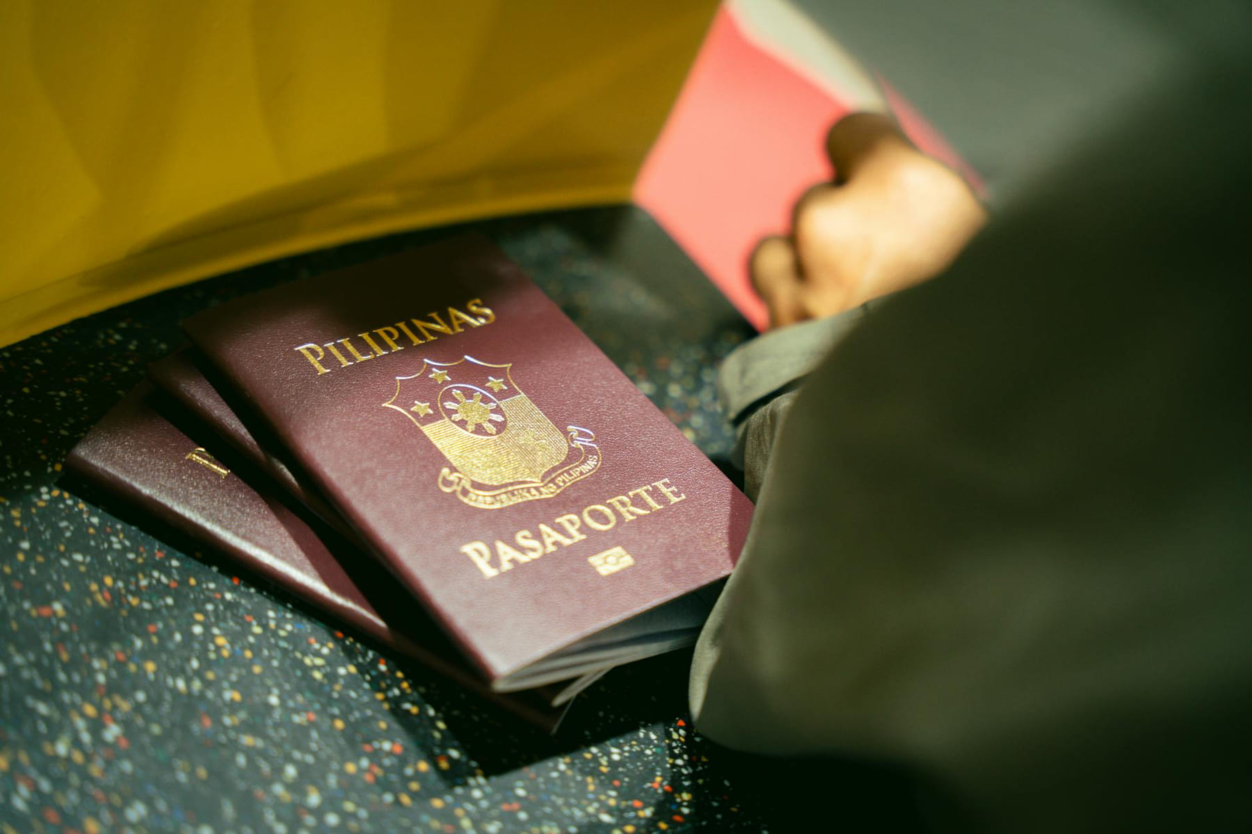 A close-up shot of Filipino passports at the airport, indicating travel and identity. on Points and Pathways