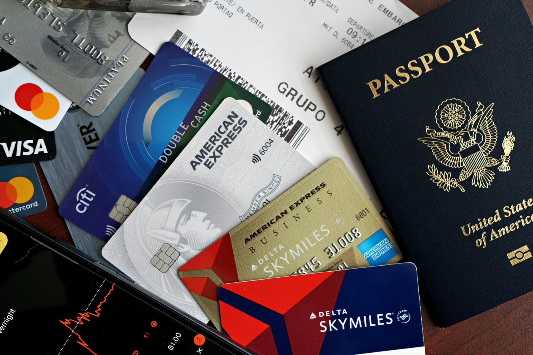 A collection of travel essentials including a passport, credit cards, and a boarding pass. Ideal for travel and finance concepts. on Points and Pathways