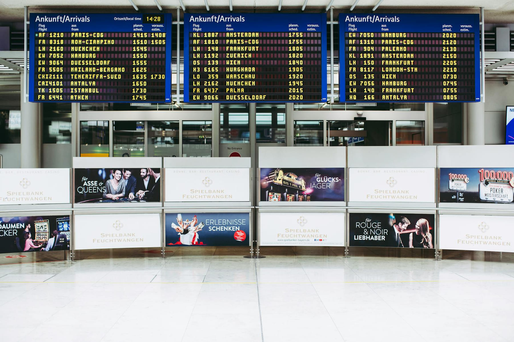 Electronic displays showing flight arrivals at Nuremberg Airport terminal. on Points and Pathways