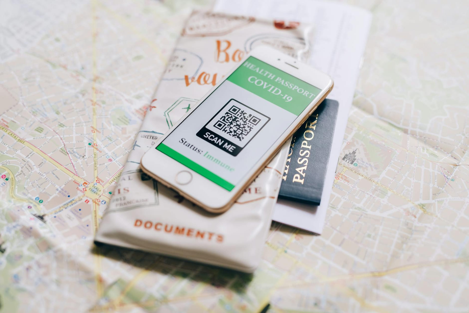A smartphone displaying a COVID-19 health passport on a map with a travel passport. on Points and Pathways
