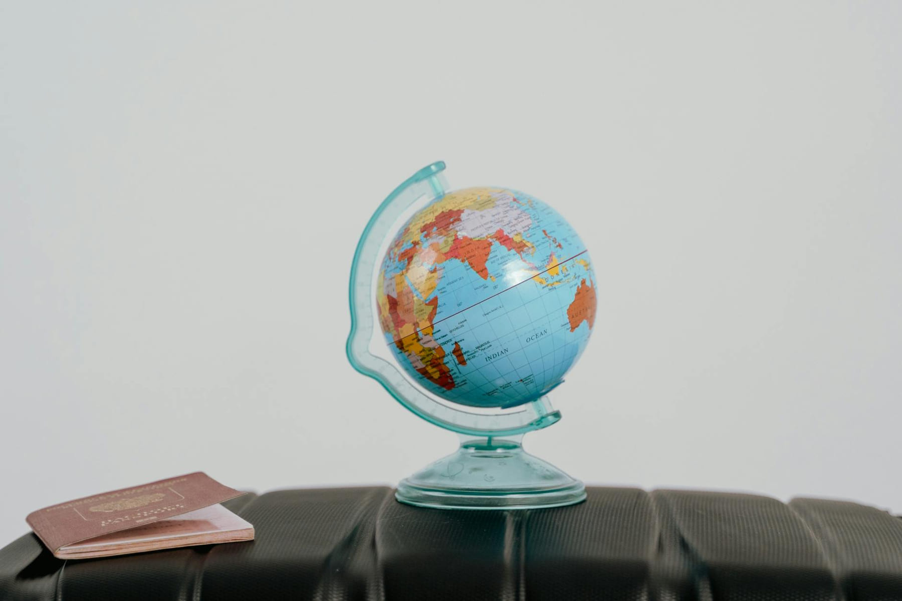 A globe and passport on a suitcase, symbolizing travel planning and wanderlust. on Points and Pathways