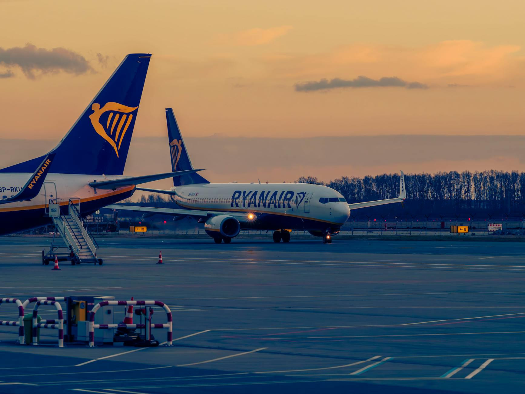 Ryanair planes on the runway at Wrocław Airport during a scenic sunset. on Points and Pathways