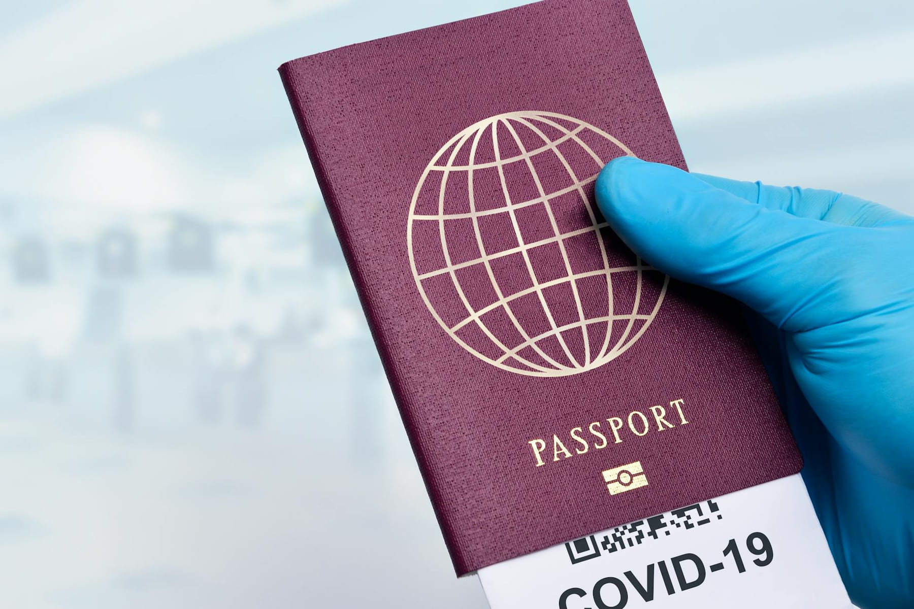 Close-up of a gloved hand holding a passport with a COVID-19 ticket, symbolizing pandemic travel. on Points and Pathways